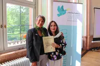 Humaira Rasuli (right) with speaker Dr. Monika Hauser