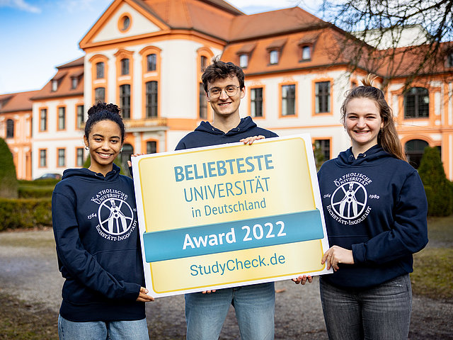 Studierende mit der Auszeichnung als beliebteste Uni 2022