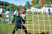Ein Spieler schießt auf ein Tor, der Torwart wird halten