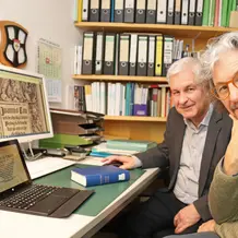 Prof. Dr. Rudolf Kilian Weigand (links) und sein argentinischer Kollege Prof. Dr. Carlos Rafael Ruta profitieren gegenseitig vom persönlichen Austausch auf der Suche nach einer treffenden Übersetzung mittelalterlicher Predigten ins Neuhochdeutsche und Spanische. (Foto: Schulte Strathaus/upd)